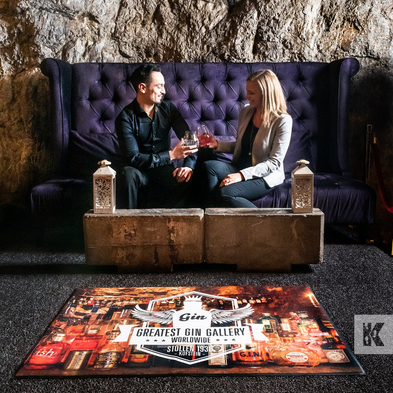 Stollen 1930 Kufstein Gin Bar printed in highest resolution on a floor mat, a couple drinking gin on a purple couch