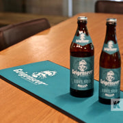 Geigenseer beer bottles on a branded counter mat