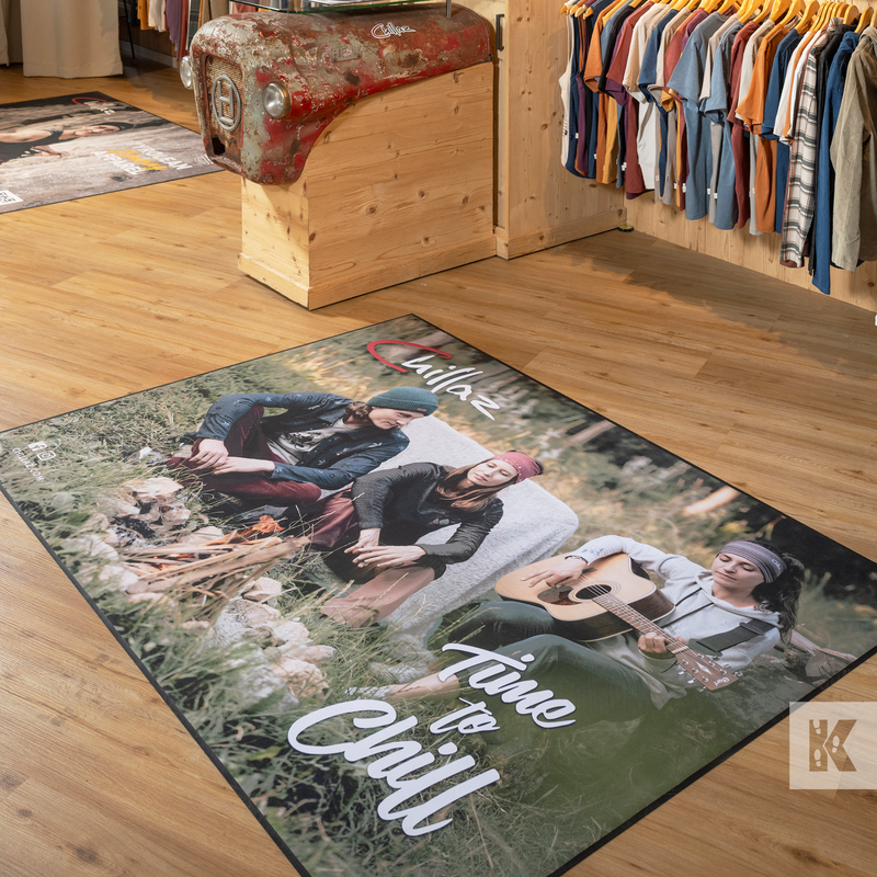 Personalized rug with a design of people around a campfire and text 'Time to Chill' on a wooden floor.