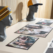 Mannequin heads wearing beanies with printed photos on a table.