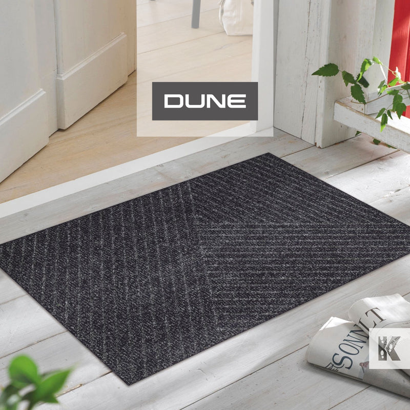 Dune mat in front of door on a wooden porch and newspaper