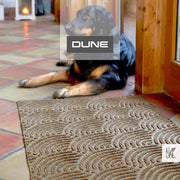 Terracotta floor tiles with a Dune embossed mat and a black dog