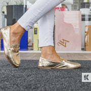 Lady walking across a grey mat in a shopping centre