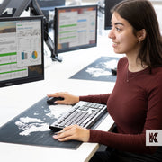 Lady using a computer with a desk planner mat