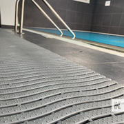 Gray modular floor system with a pool area in the background