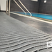 Gray modular floor system with a pool area in the background