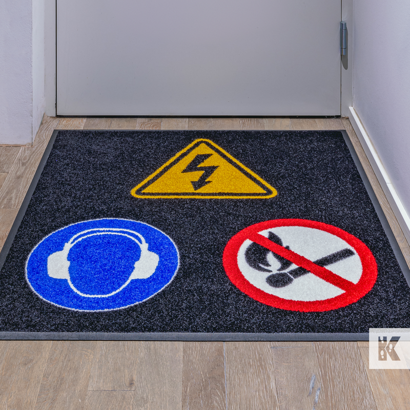 Safety warning signs on a door mat