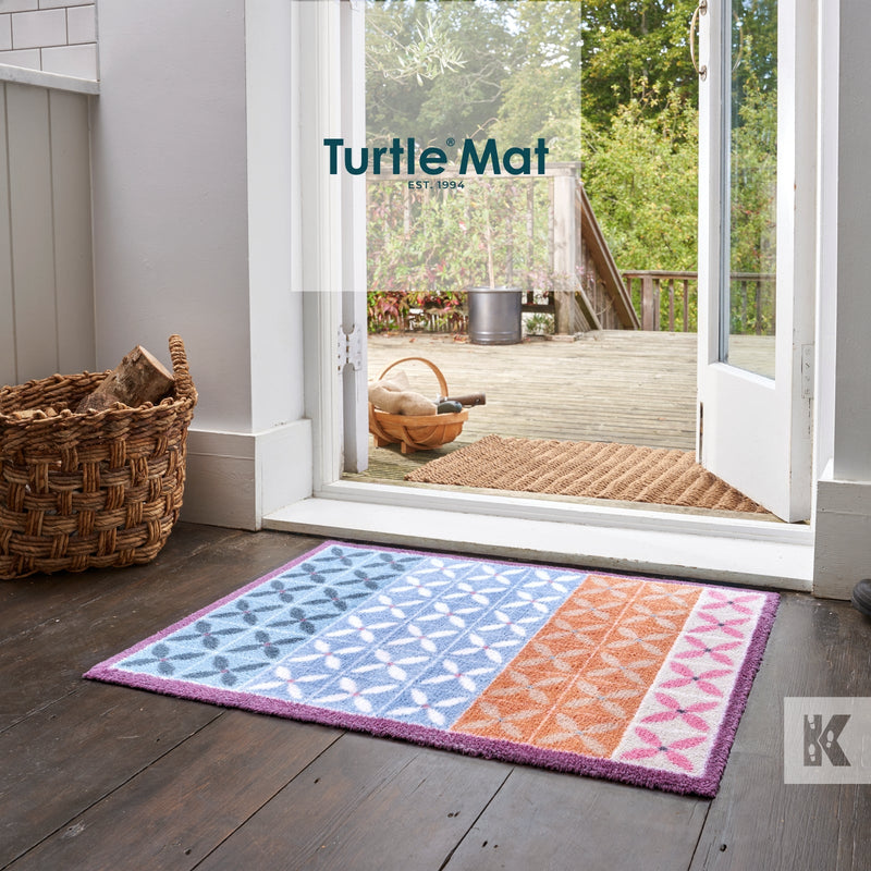 Colourful pattern on a Turtle Mat with a door leading out onto decking