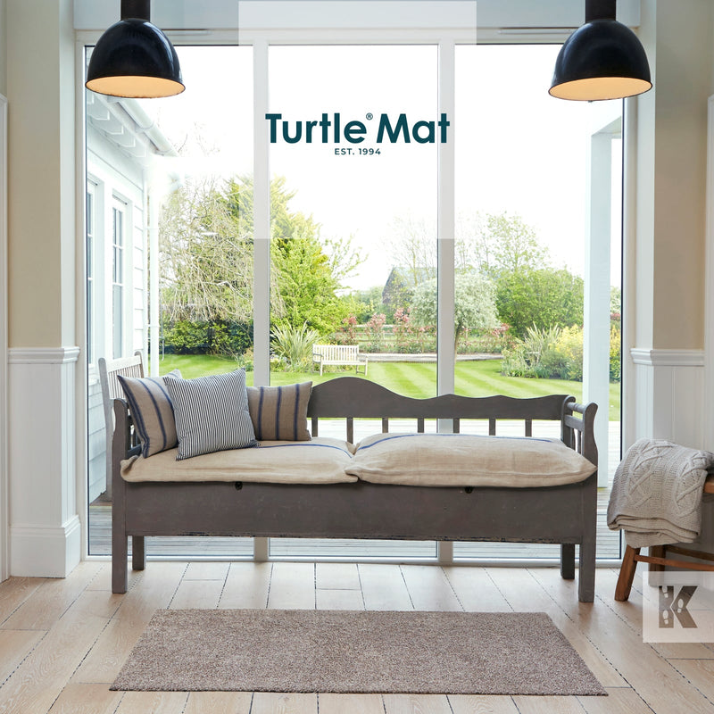 Turtle Mat scene with a couch and garden view and a latte mat on a wooden floor