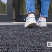 Outdoor mat close up with woman in trainers