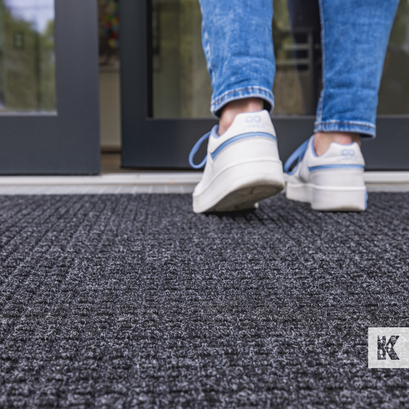 Outdoor mat close up with woman in trainers