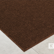 Brown doormat on a light gray floor
